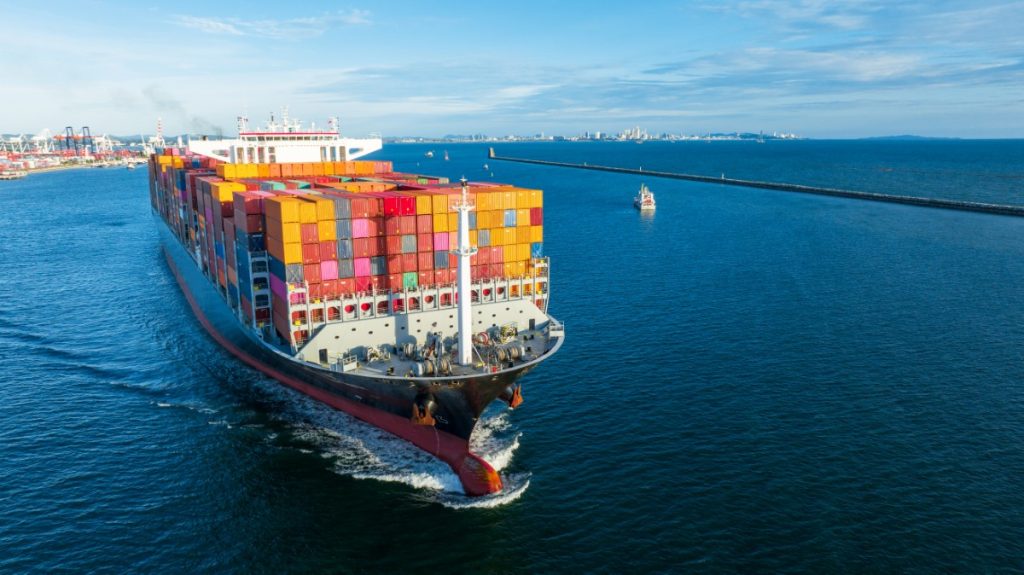aerial-side-view-of-cargo-ship-carrying-container-2024-12-08-00-48-31-utc.jpg